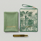 Green pouch with palm tree design, gold pen, and green fabric item on a light gray background