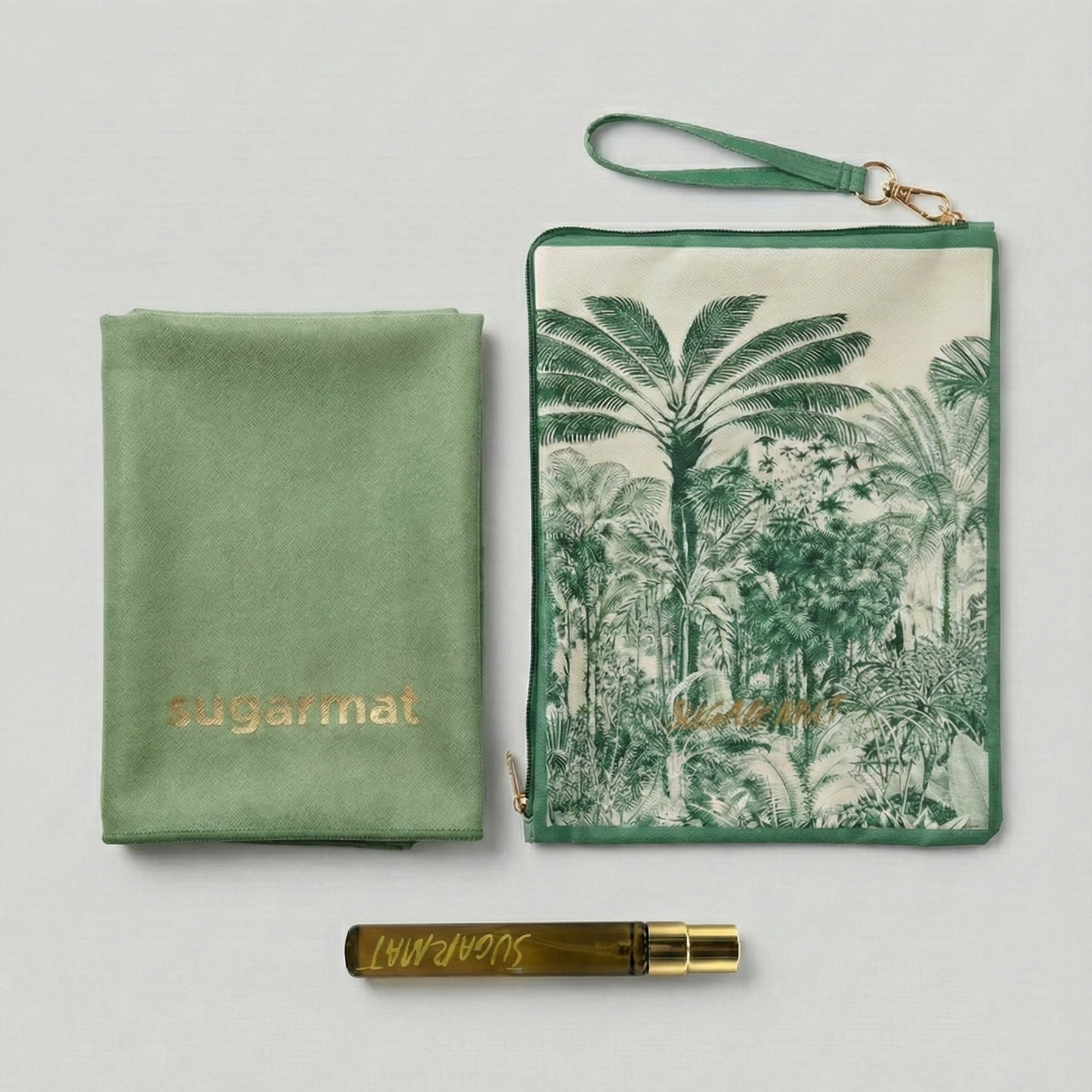 Green pouch with palm tree design, gold pen, and green fabric item on a light gray background
