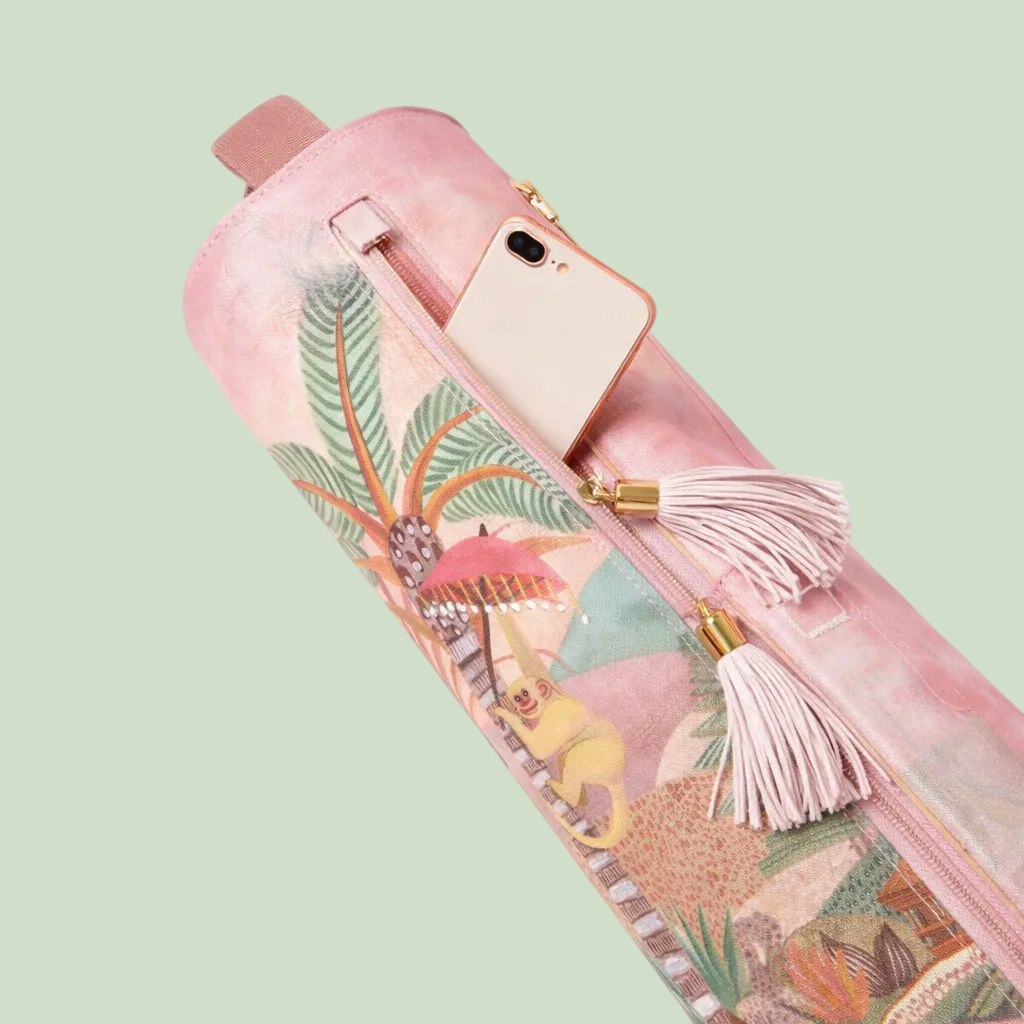 Pink umbrella with tropical design and tassels on a white background