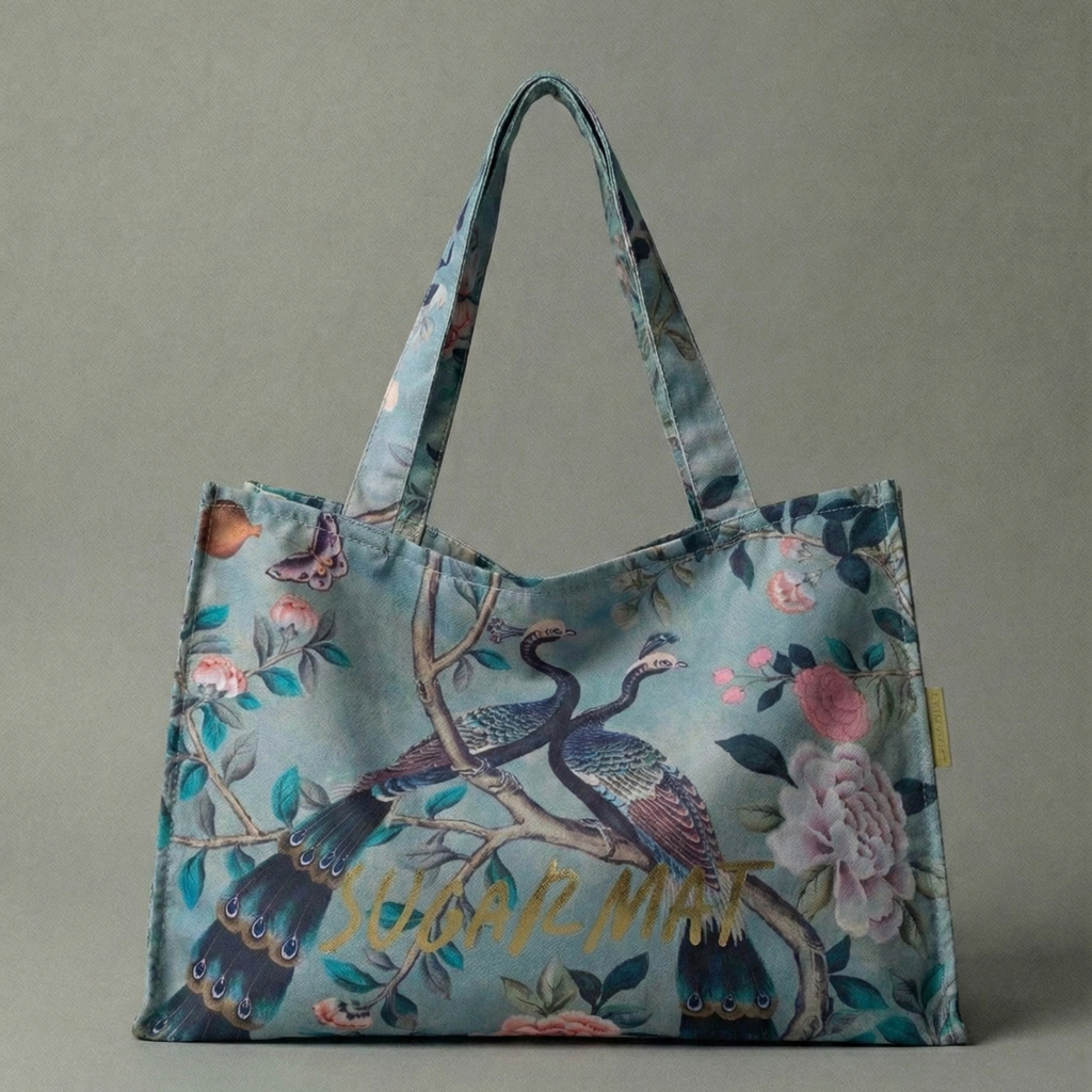 Floral and bird patterned tote bag with 'SUGAR MAT' text on a gray background
