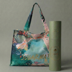Colorful tote bag with floral design next to a cylindrical product on a gray background