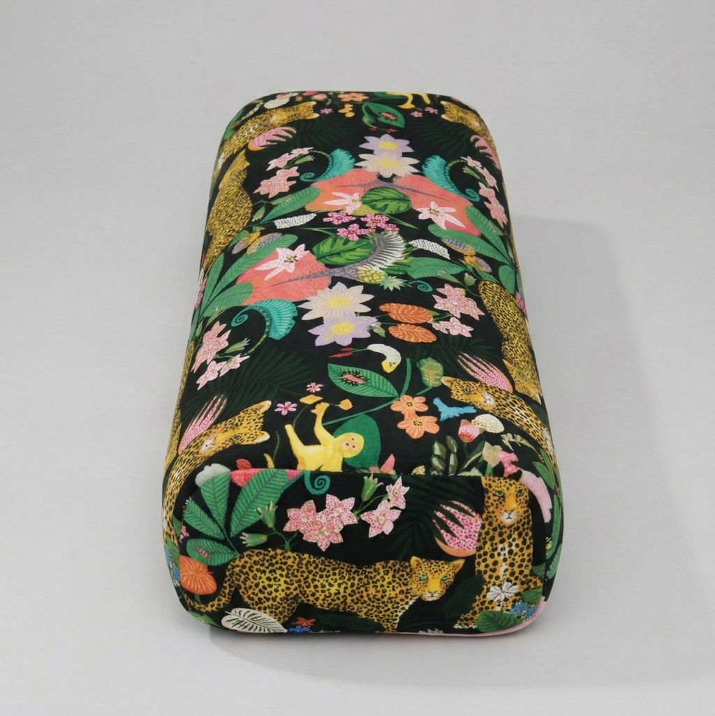 Floral and animal patterned makeup bag on a gray background