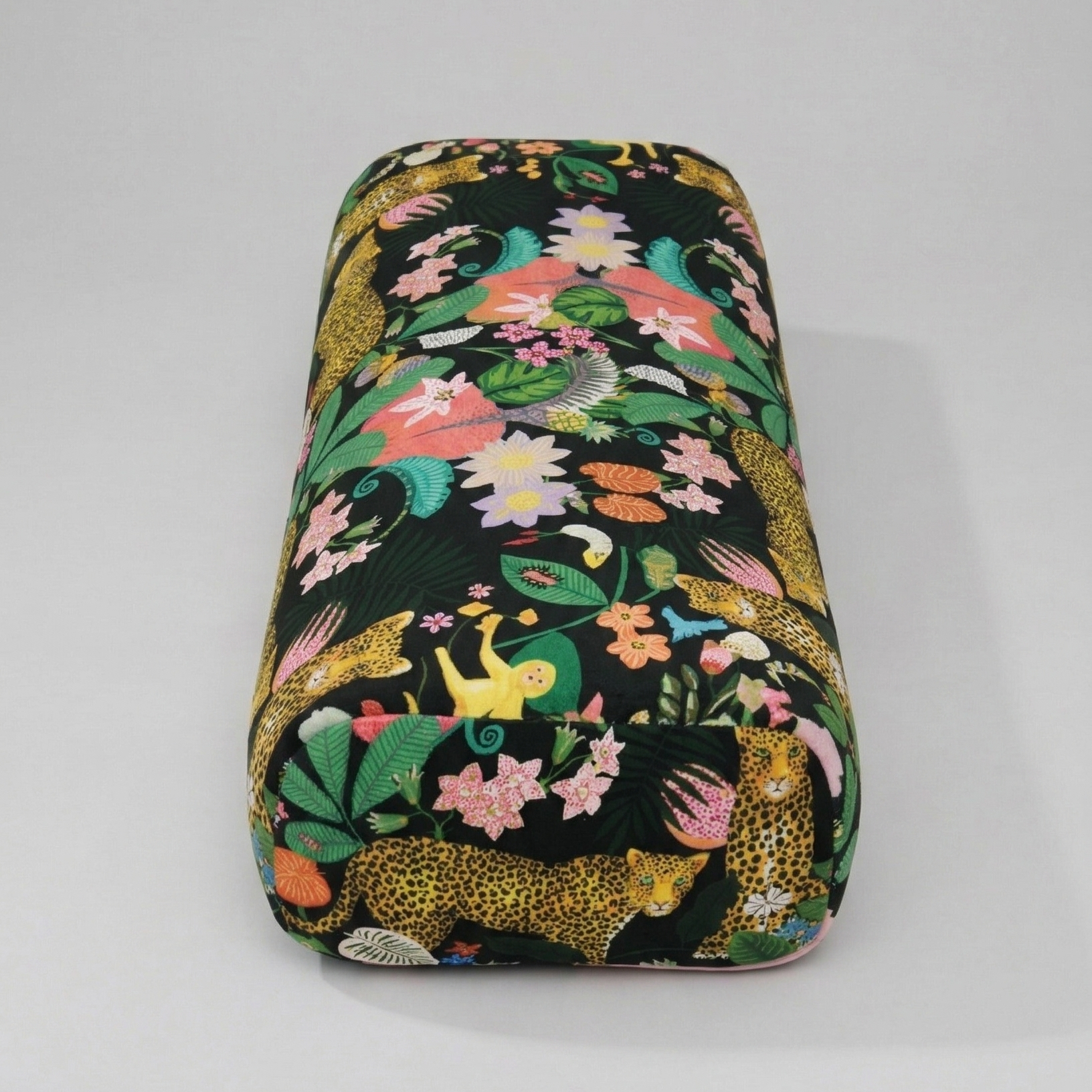 Floral and animal patterned makeup bag on a gray background