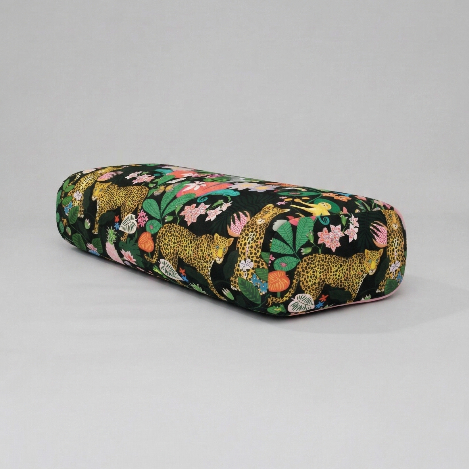 Floral-patterned cylindrical pouch on a gray background
