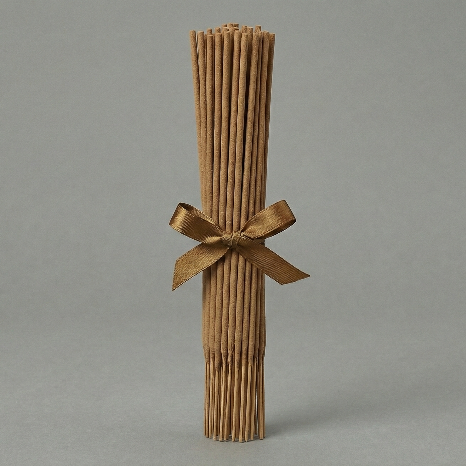 Bamboo sticks tied with a ribbon on a gray background