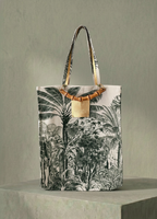 Tote bag with palm tree design on a neutral background