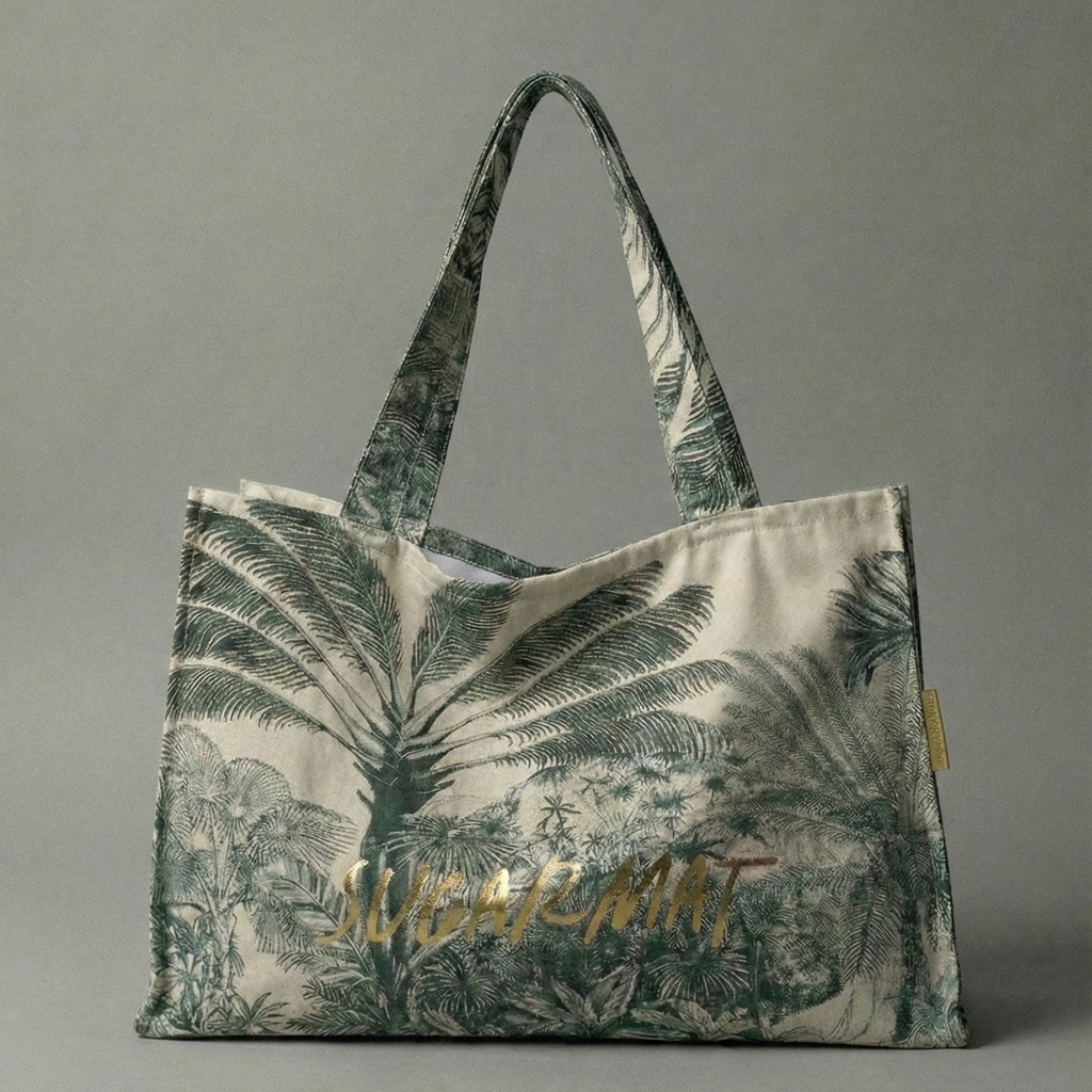 Tote bag with palm tree design and 'Lush' branding on a gray background