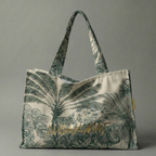 Tote bag with palm tree design and 'Lush' branding on a gray background