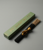 Incense sticks with a green box on a gray background
