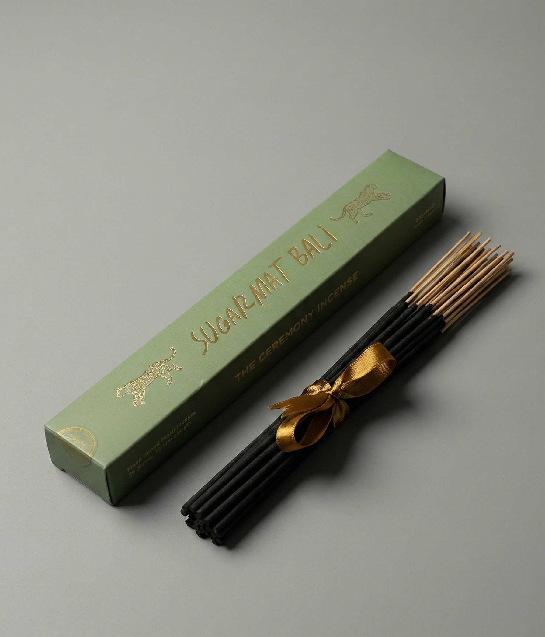 Incense sticks with a green box on a gray background