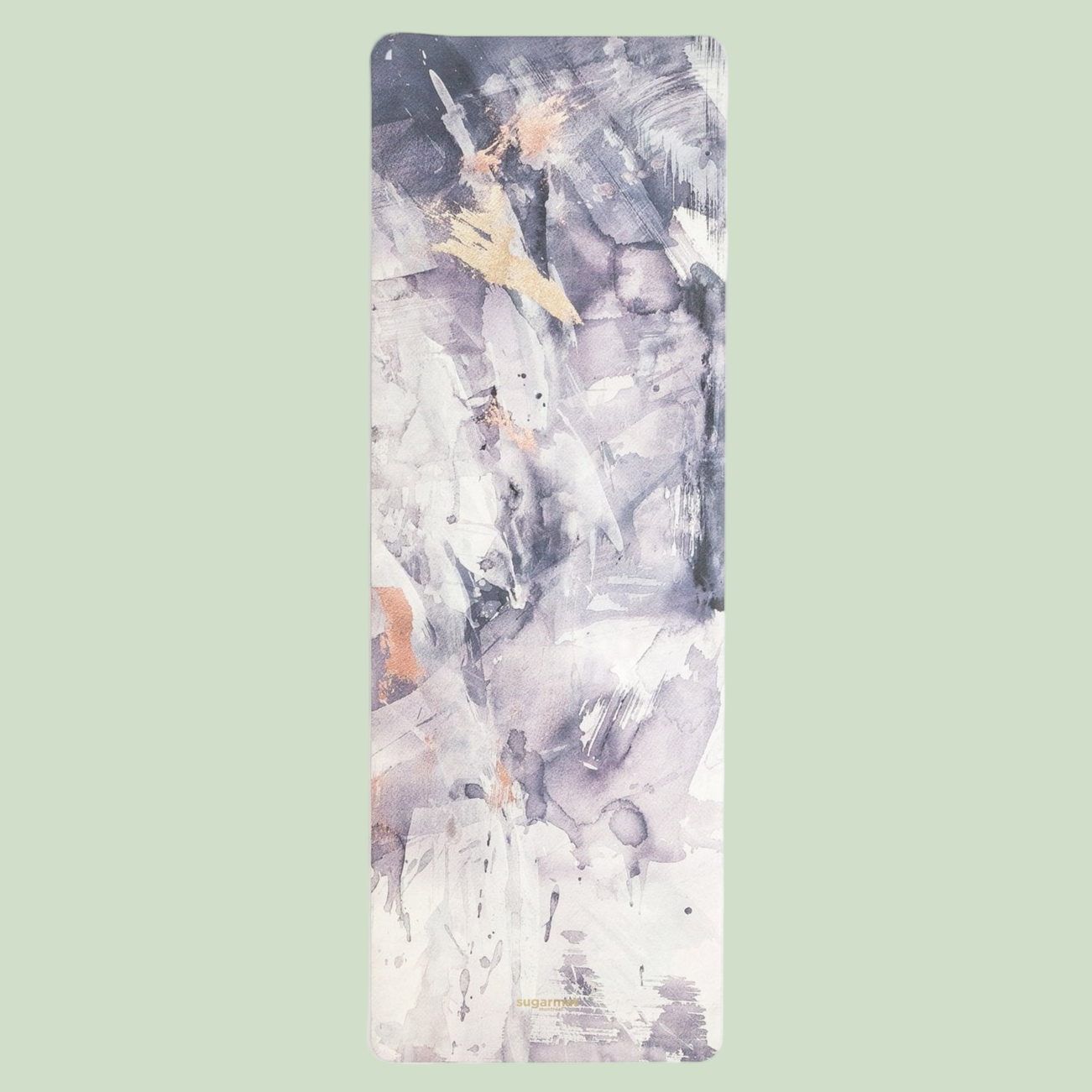 A suede yoga mat with abstract purple artwork, rolled up on a white background.