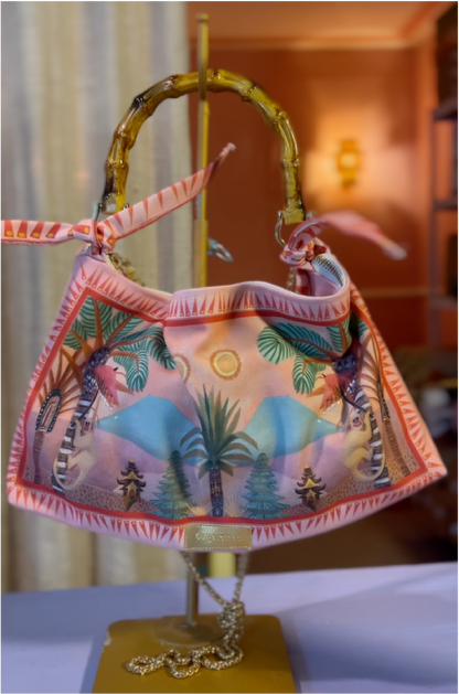 Colorful handbag with palm tree design on a stand