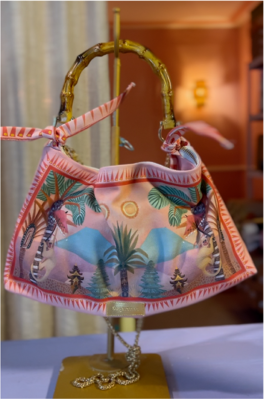 Colorful handbag with palm tree design on a stand