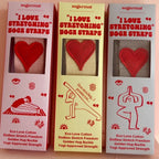Three boxes of 'I Love Stretching' sock straps with red hearts on a beige background.
