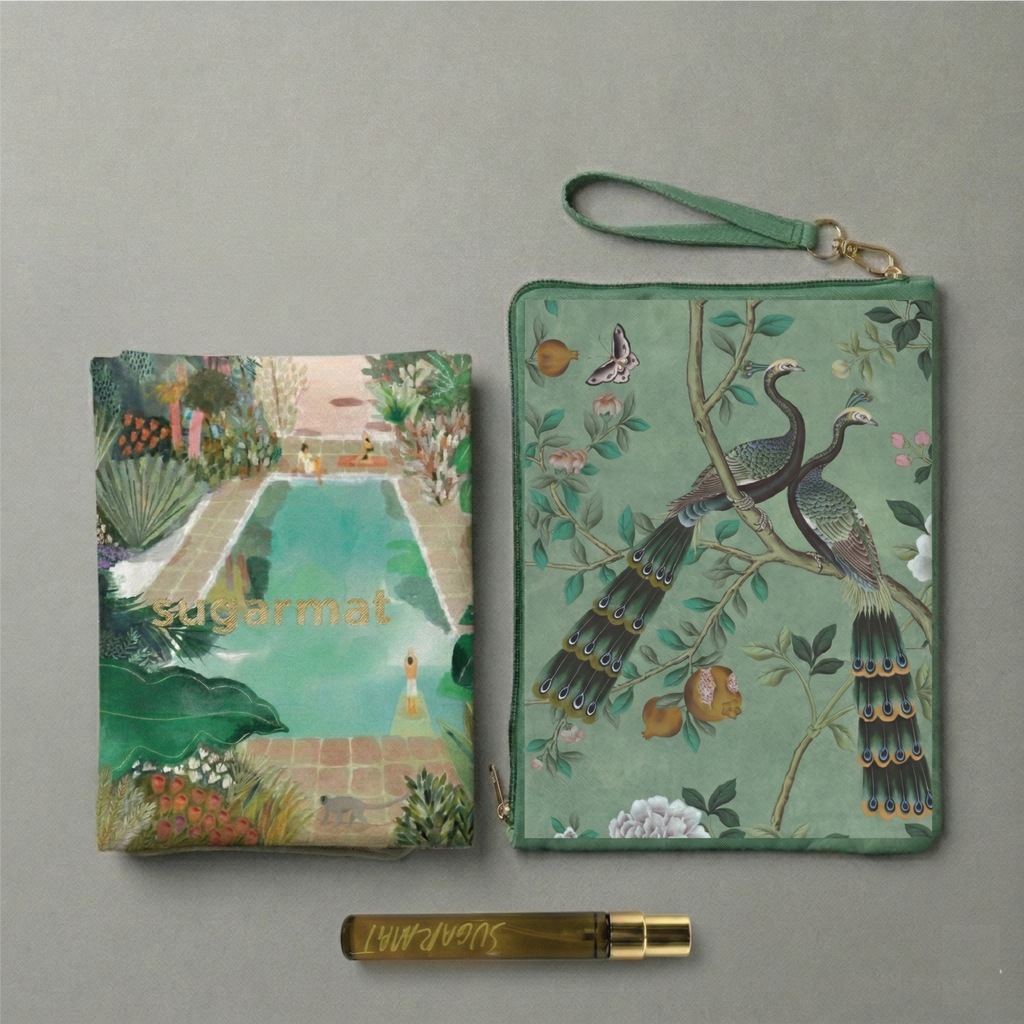 Two green handbags with artistic designs on a gray background